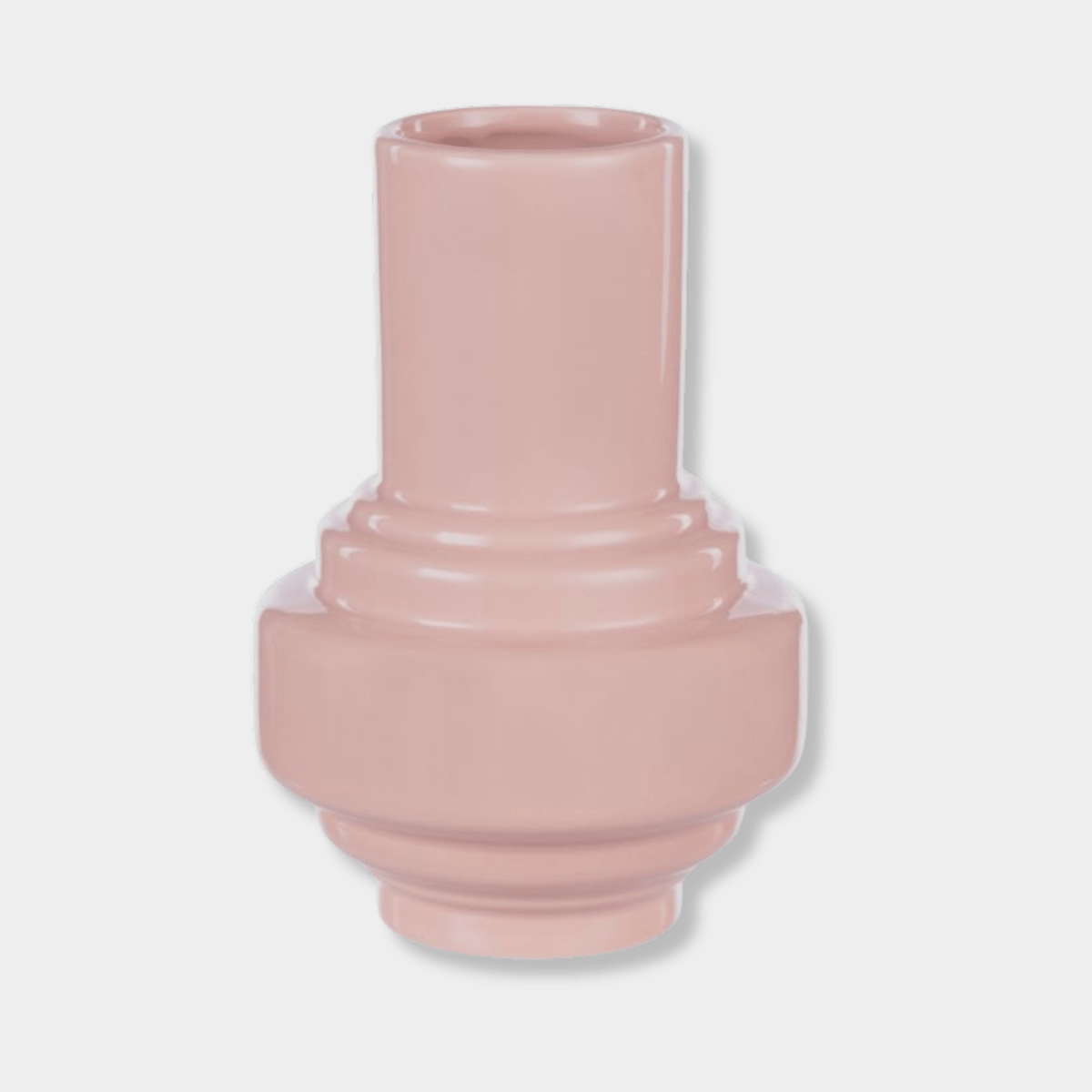 Small Merrik Vase in sugary pink with a geometric shape and high-gloss lacquer finish, made of clay.