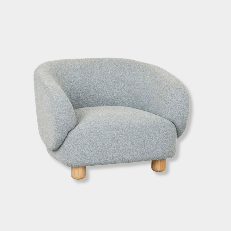 GlobeWest Flo occasional chair in Nimbus upholstery with natural ash wood legs, featuring wraparound back and modern design