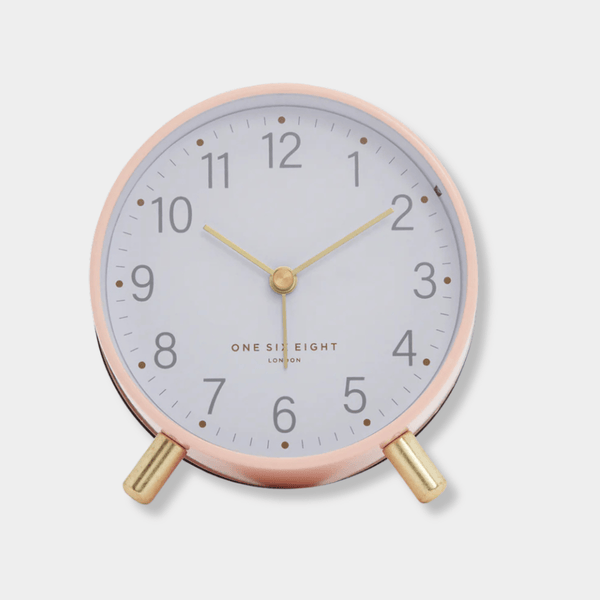 Maisie Silent Tick Alarm Clock in blush with gold legs and hands, vintage-inspired design, silent ticking, and built-in nightlight