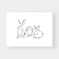 Minimalist black and white line art print of three rabbits titled Gigi's Rabbits wall art.