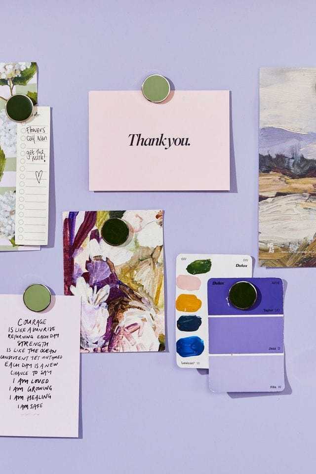 Mustard Made The Buttons sage green magnets holding notes and cards on a lavender wall