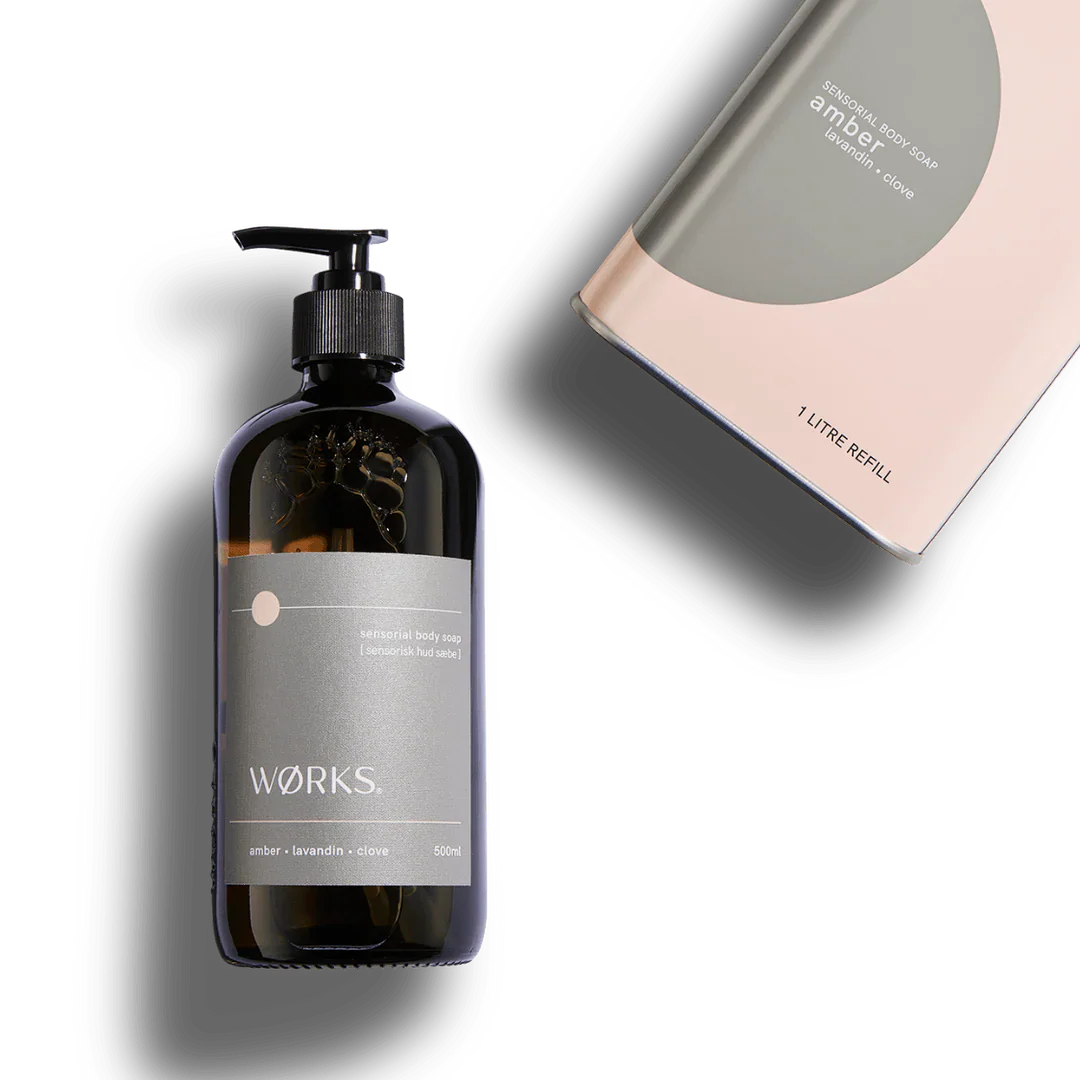 Works Body Soap amber 500ml bottle and 1-litre refill pack with warm amber, lavandin, and clove scent in minimalist packaging