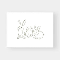Minimalist line art illustration of three white rabbits with green accents on premium fine art paper wall print titled Gigi's Rabbits