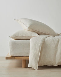 Sova Savanna linen fitted sheet and pillowcases styled on a bed base