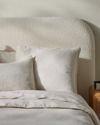 Bed styled with Weave Home Sova Savanna linen pillowcases and a boucle bedhead