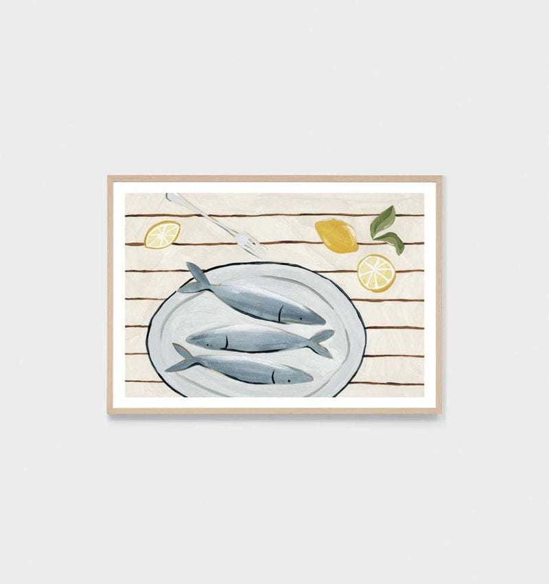 Middle of Nowhere Amalfi Catch Blue print featuring fish on a plate with lemon slices, framed in oak with white border.