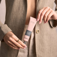 Model holding WORKS Amber Hand Cream