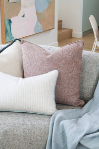 norsu STUDIO Aura Reversible Cushion in terracotta styled on a grey sofa