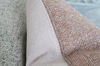 Close up of the terracotta basketweave and lilac linen fabrics