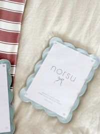 Blue scalloped norsu Studio magnetic photo frame on beige fabric background