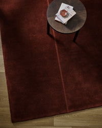 Baya Bastion Floor Rug - Claret styled in a room