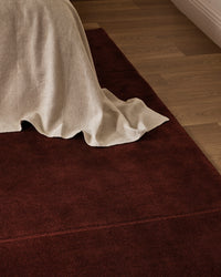 Baya Bastion Floor Rug - Claret styled in a room