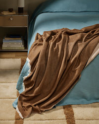 Baya Langford Throw - Coffee styled on a bed