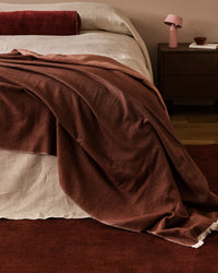 Baya Langford Throw - Raisin styled on a bed