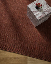 Baya Linden Floor Rug - Brick styled in a room