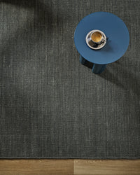 Baya Linden Floor Rug - Petrol styled in a room