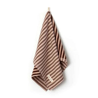 Brown and beige striped Between The Lines Tea Towel hanging with a label, made of 100% cotton, 75x50cm size