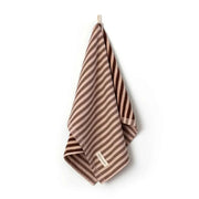 Brown and beige striped Between The Lines Tea Towel hanging with a label, made of 100% cotton, 75x50cm size