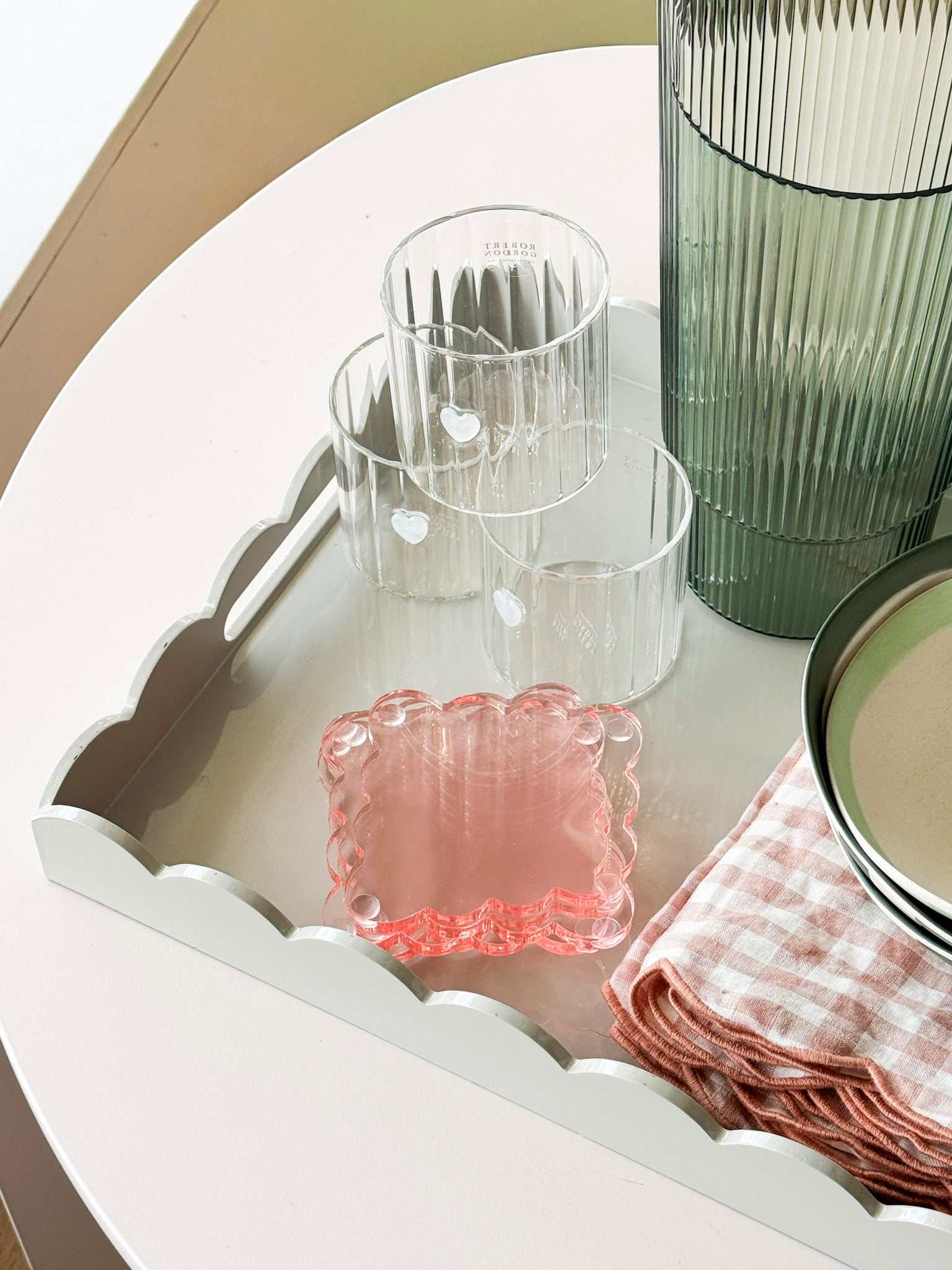 norsu STUDIO rectangular scalloped sage tray with glassware and pink cloth on white table