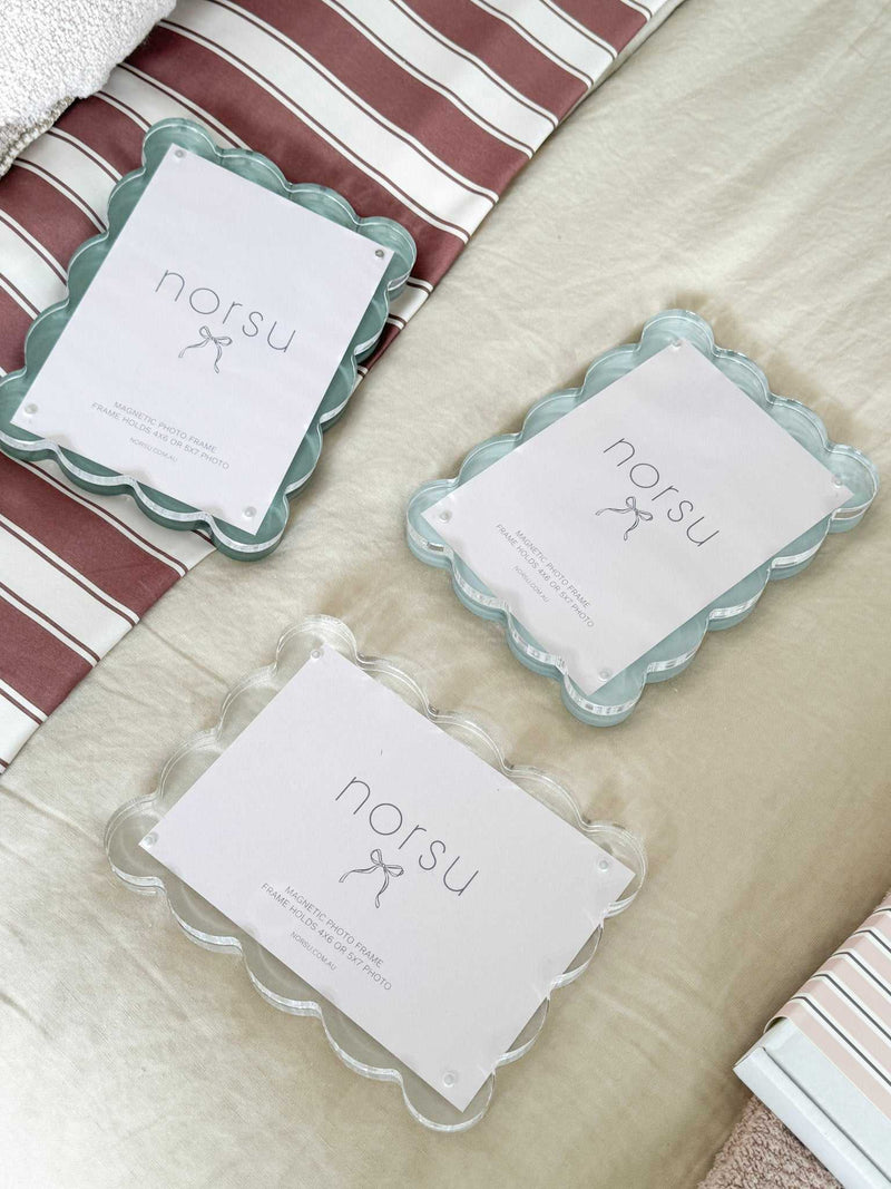 norsu Studio Scalloped Magnetic Photo Frames with acrylic scalloped edges in pastel colors on fabric background