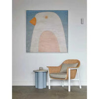 Powder blue Artie Wave Ripple side table with abstract ripple timber veneer base and Carrara marble top next to rattan armchair in modern room