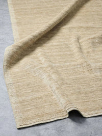 Chelsea Rug in camel color handloomed from 100% wool with refined border detailing