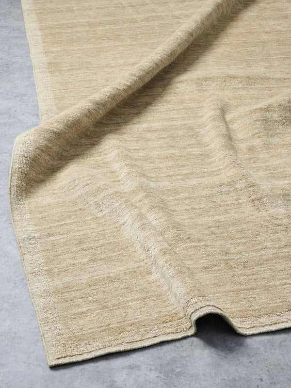 Chelsea Rug in camel color handloomed from 100% wool with refined border detailing