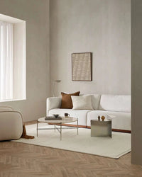 Ivory Baya Clifton Floor Rug in a minimalist living room with white sofa and neutral decor