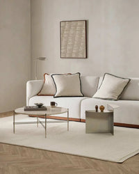 Baya Clifton Floor Rug in ivory with hand-knotted wool loop pile in a modern living room setting