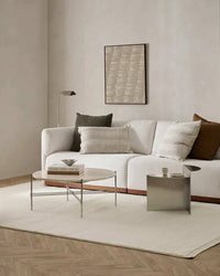 Ivory Baya Clifton Floor Rug with looped pile in a modern living room setting