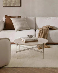 Baya Clifton Floor Rug ivory wool hand-knotted loop pile in modern living room with white sofa and round coffee table