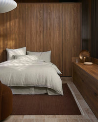 Weave Home Sova Savanna linen bedding in a timber panelled bedroom