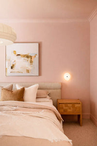 Modern bedside table styled professionally with decorative items and lighting