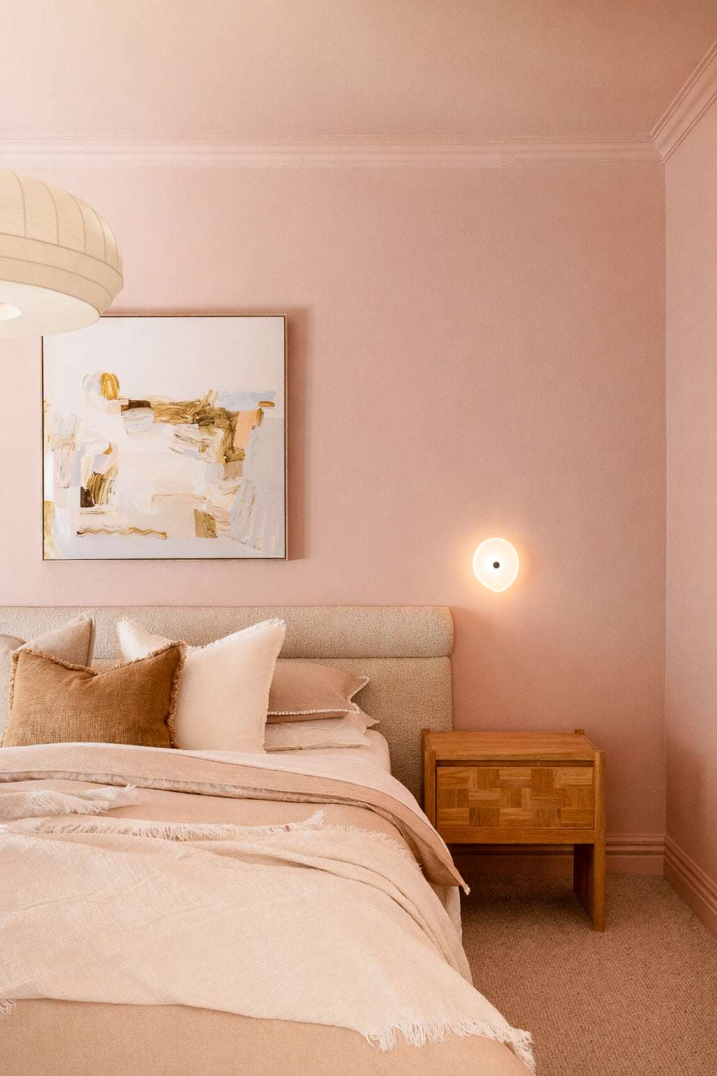 Modern bedside table styled professionally with decorative items and lighting