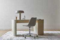 Minimalist GlobeWest Orson Round Desk in putty color with curved edges, two drawers, ash veneer finish, and a modern swivel chair placed on a light area rug.