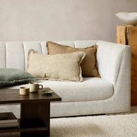 Baya Dover Cushion natural lumbar cushion with soft fringed edges on a beige sofa