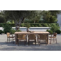 Outdoor GlobeWest Montana Raft Dining Table in aged teak with slatted top and solid corner legs, seating eight chairs.