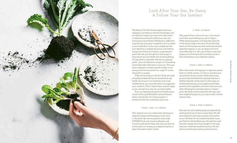 The Beauty Chef Gut Guide book by Carla Oates with fresh greens and meal plans for gut health