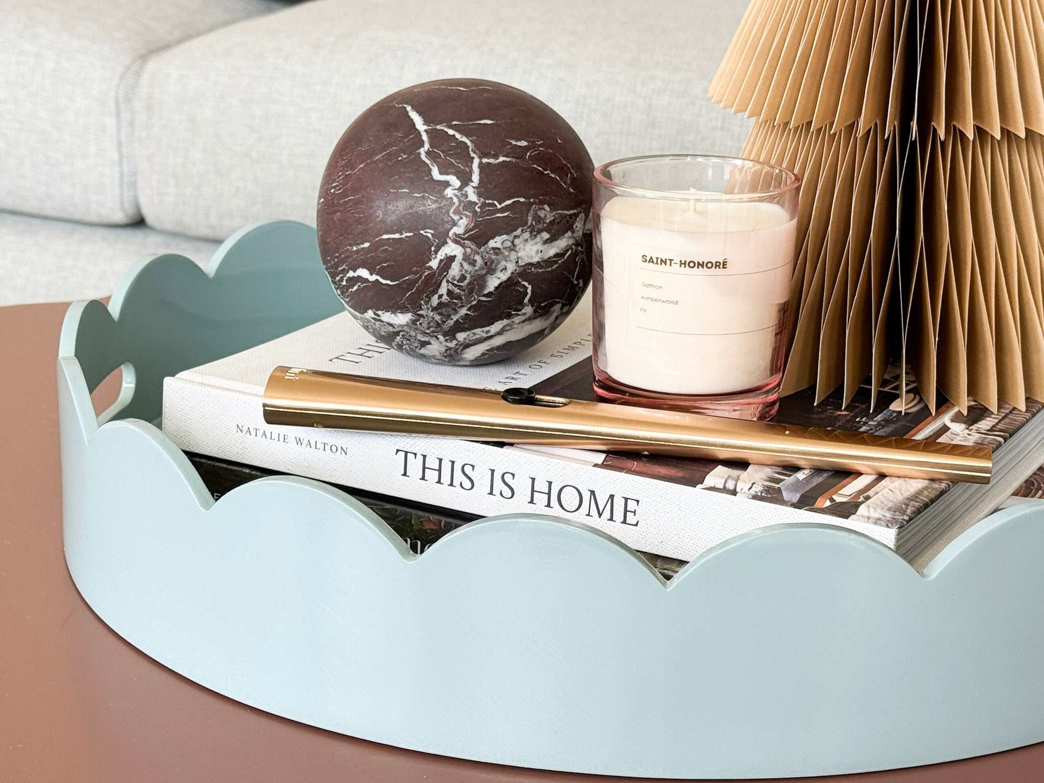 norsu Studio Round Scalloped Tray in duck egg blue with high-gloss lacquer finish and scalloped edges styled on a surface with decorative items