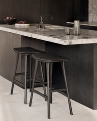 Ethnicraft Osso stool - Black Oak/ Black Leather, styled in a room setting