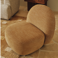 Liora Swivel Chair Oat styled in a living room