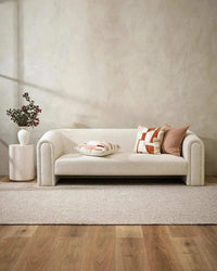 Eadie Flaxmill Cushion in clay on modern white sofa with neutral decor and wooden floor