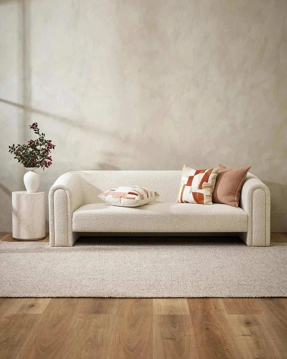 Eadie Flaxmill Cushion in clay on modern white sofa with neutral decor and wooden floor