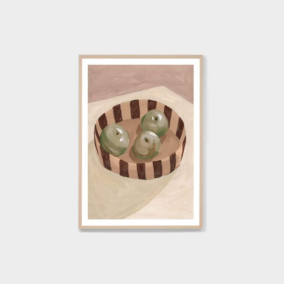 Middle of Nowhere Fruit Bowl print with three green apples in a striped bowl framed in oak with white border