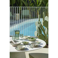 Davis & Waddell Salad Bowl in dark green bamboo fibre with wiggly striped design on outdoor dining table near pool