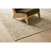 GlobeWest Tepih Neptune Rug in silver grey hand-woven wool blend on wooden floor under chair