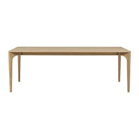 Globe West Huxley Curve Dining Table in natural oak with solid oak legs and oak veneer top, available in multiple sizes.