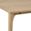 Close-up of Globe West Huxley Curve Dining Table corner with oak veneer top and solid oak leg in natural oak finish