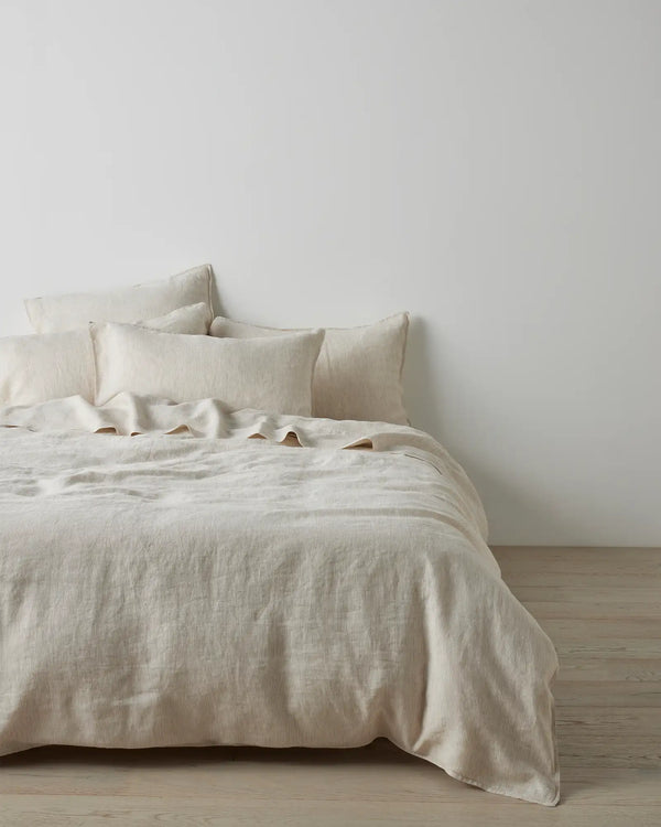 Weave Home Sova flat sheet in Savanna pinstripe linen folded back over a made bed