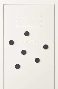 Set of six dark slate-colored Mustard Made magnetic buttons on a white surface